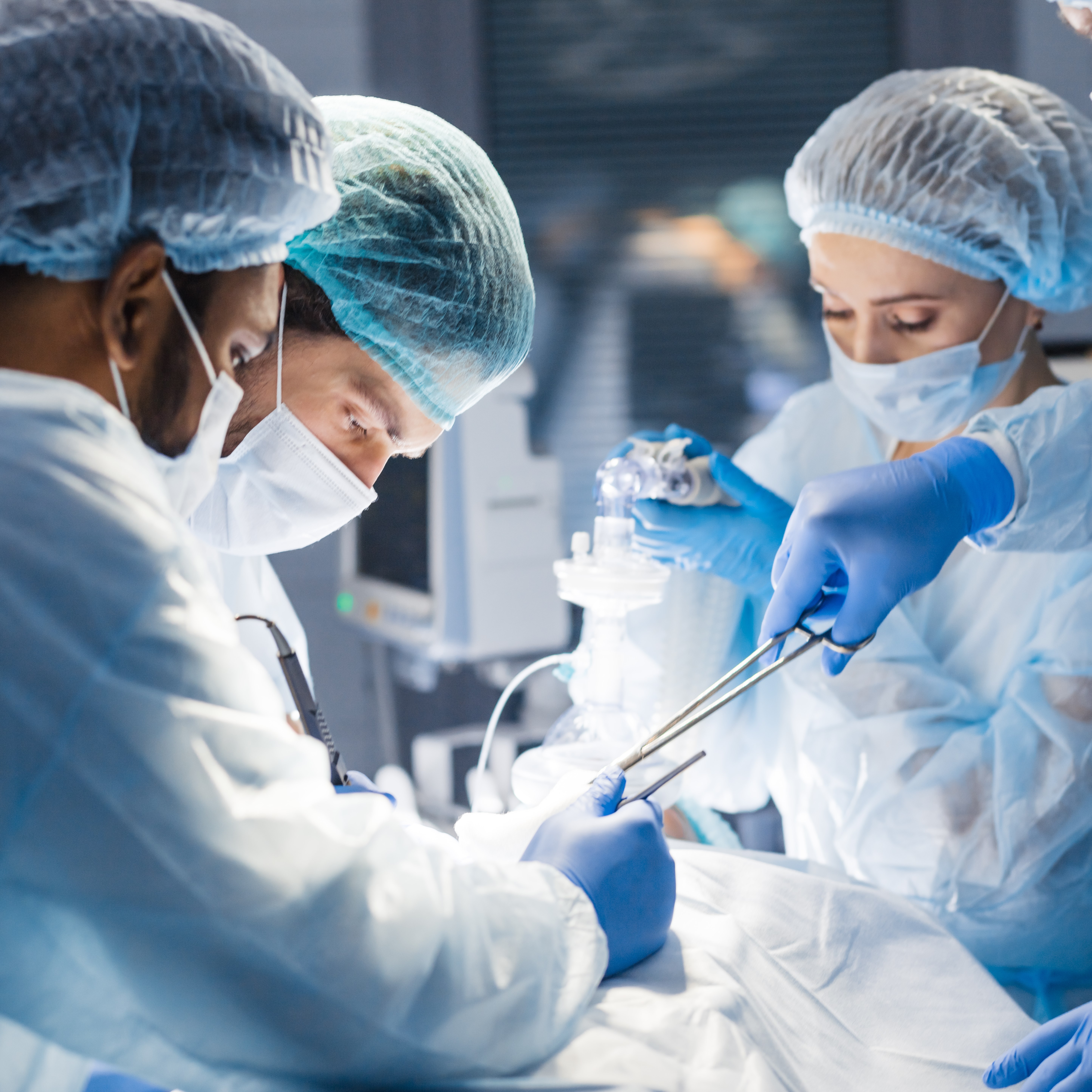 Four surgeons operate on a patient, putting their physician training to use as they perform a complex procedure.