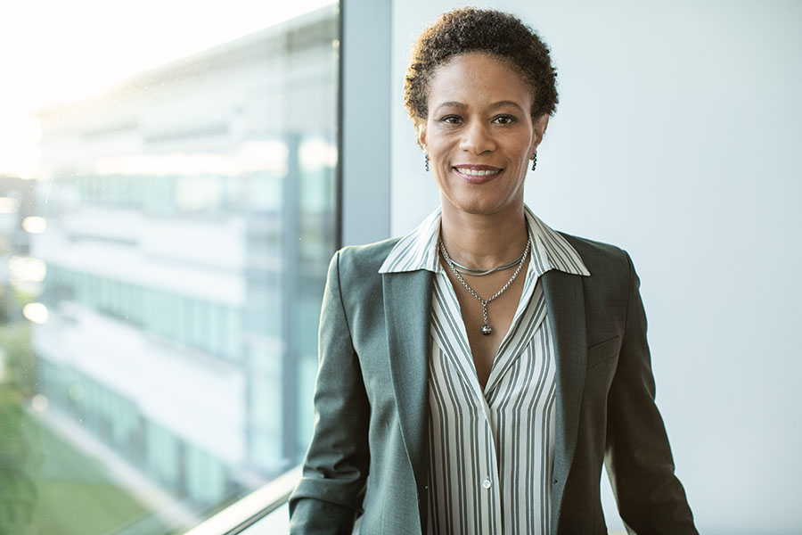 A photo of Kathryn Unger, VP of ESG, a Black woman with short hair and silver necklaces, wearing a business suit.